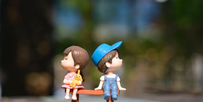 Love - Boy and Girl Sitting on Bench Toy
