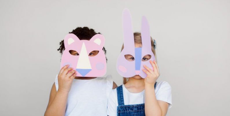 Educational Fun - Two Kids Covering Their Faces With a Cutout Animal Mask